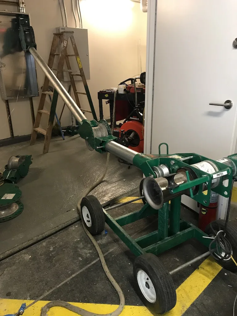 Cable puller set up for a commercial feeder pull by Electric A/C Inc in NYC