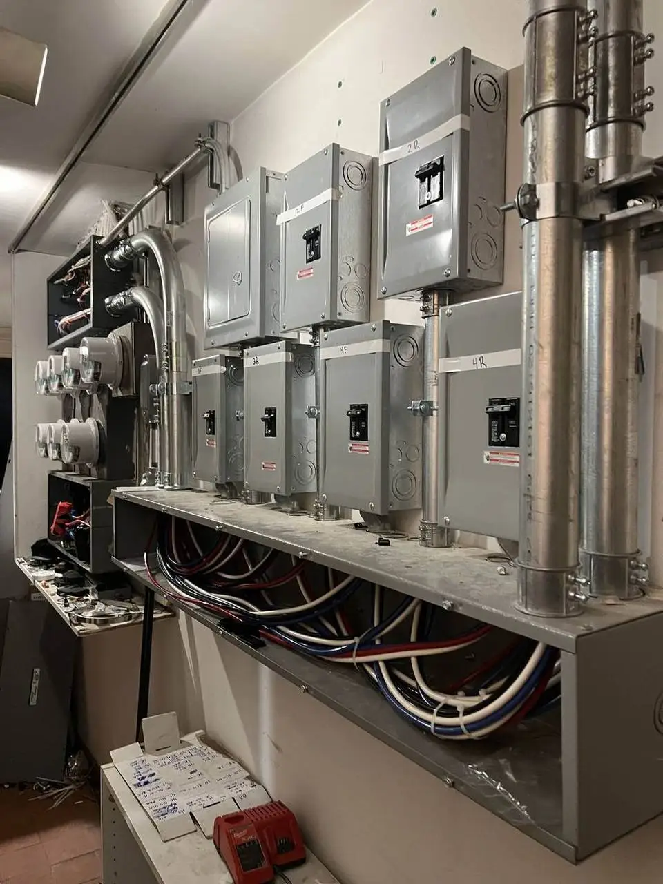 Row of electrical disconnects and meters installed by Electric A/C Inc