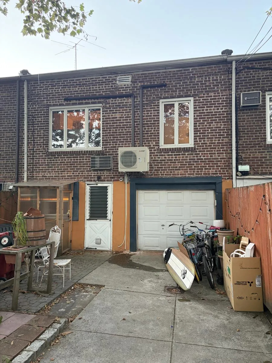Mini split condenser installed on a brick home in Middle Village, Queens